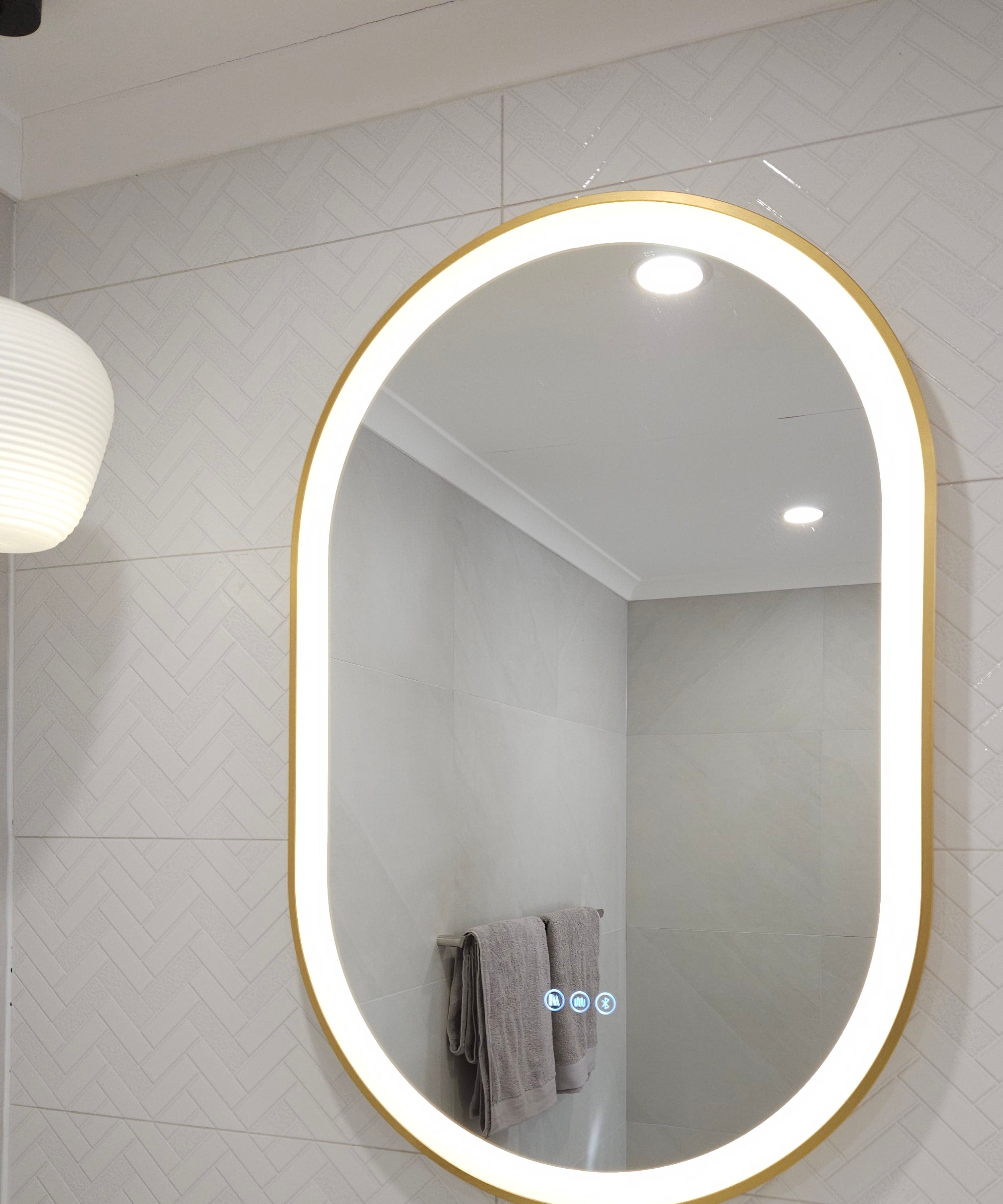 Gold-framed Oval Smart Mirror with White LED Light in White Powder Room