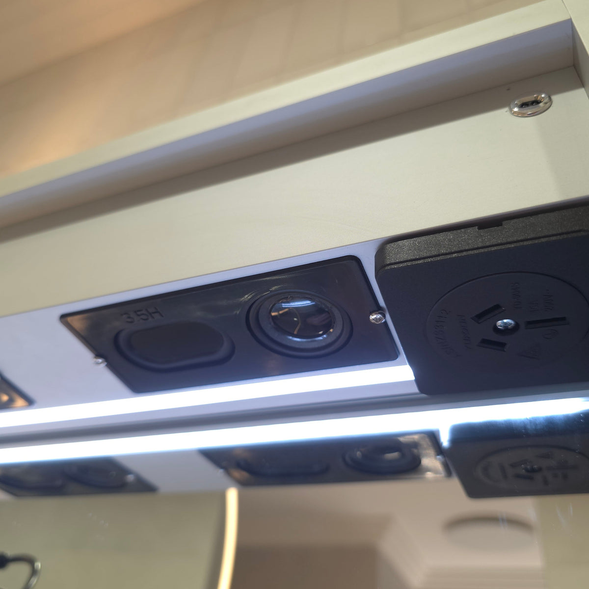 close up Frameless LED mirror cabinet with powerpoint and bluetooth speakers
