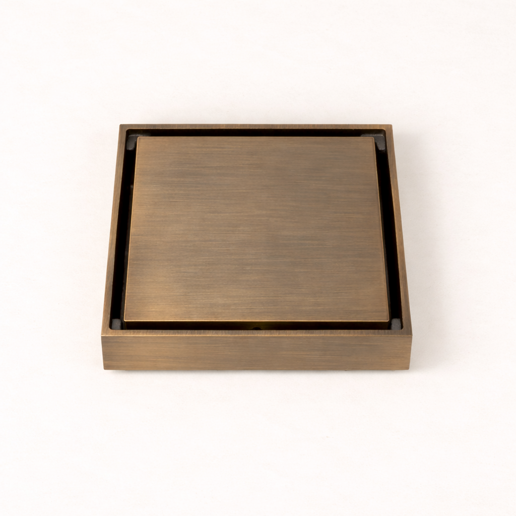Granada Tile Insert Floor Waste in Antique Brass, three-quarter view of the cover on a plain white background