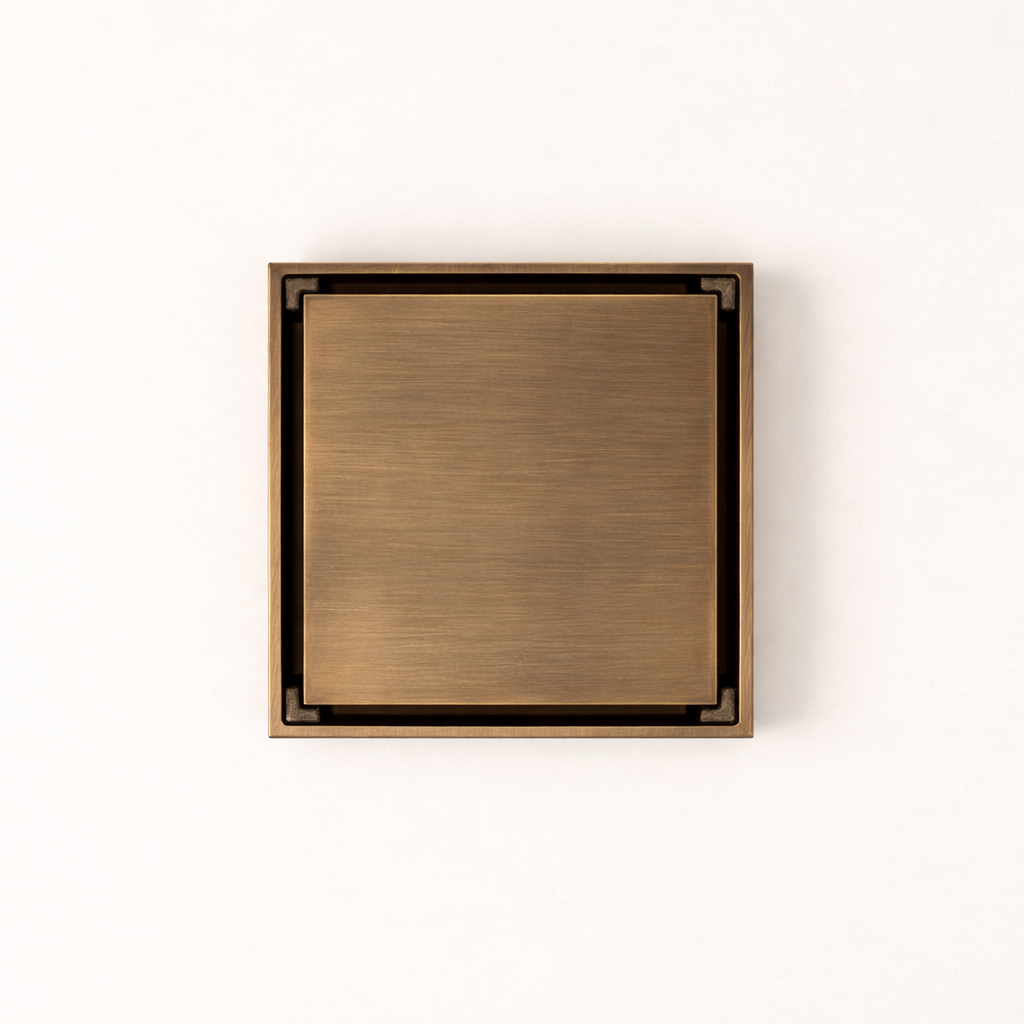 Granada Tile Insert Floor Waste in Antique Brass, top-down view of the square brushed cover on a plain white background