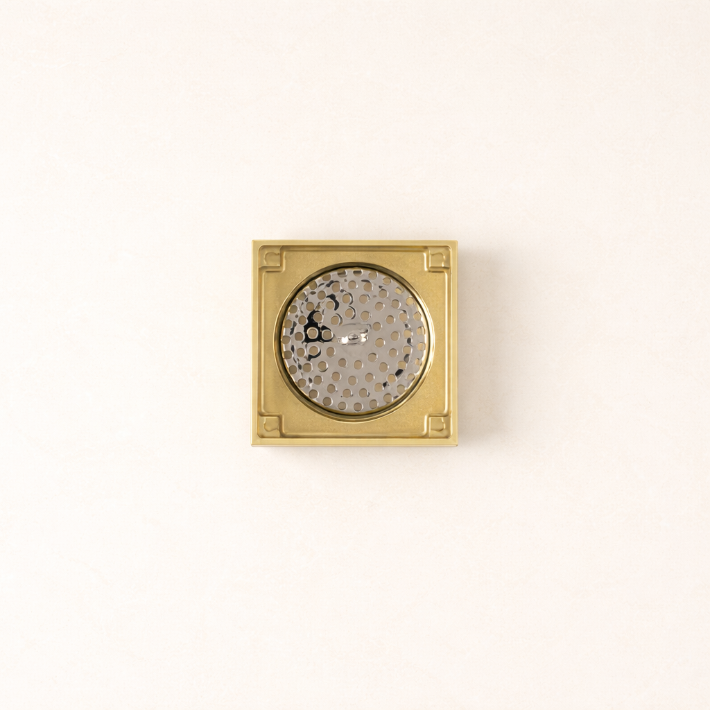 Granada Tile Insert Floor Waste in Brushed Brass, cover removed to show the round strainer on a plain white background