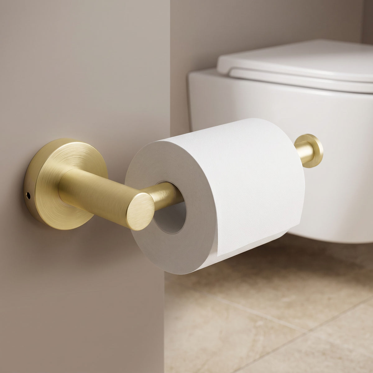 Lille Toilet Roll Holder in Brushed Brass in a bathroom