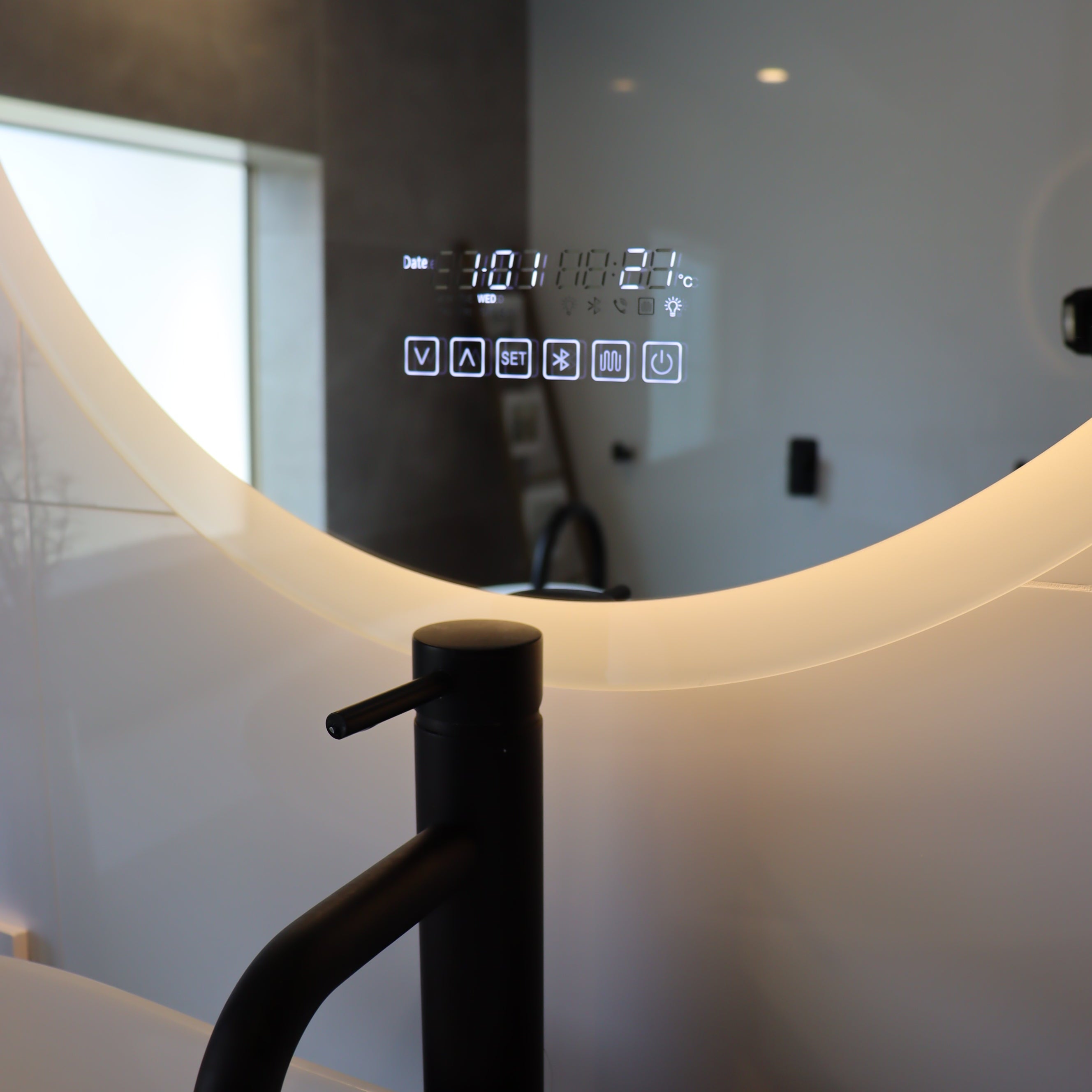 Close-Up of Oval Smart LED Mirror Control Panel: Yellow Light, White Wall, Black Faucet, Vessel Sink