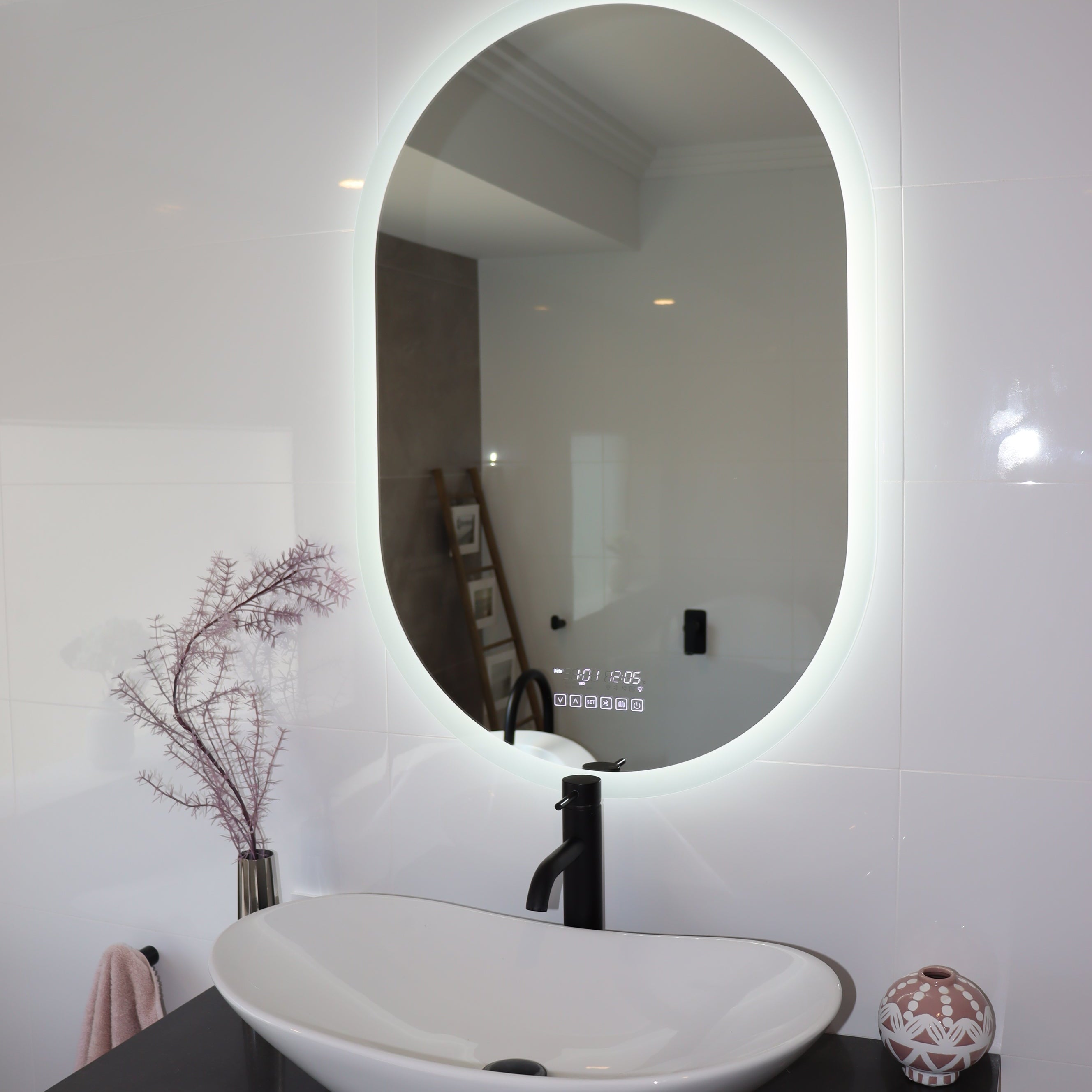 Serene white LED mirror vanity with black countertop and nature-inspired decor