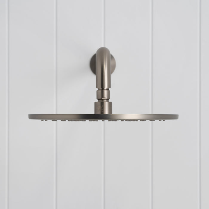 Bordeaux Wall Mounted Shower Head with Arm in Brushed Nickel, front view on a white vertical-panelled wall