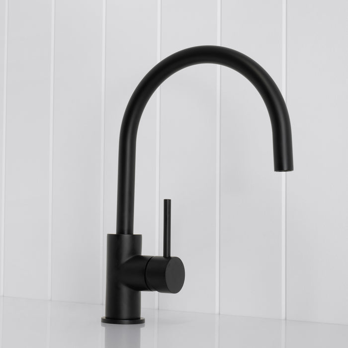 Como Kitchen Mixer Tap in Matte Black, three-quarter front view on a white vertical-panelled wall