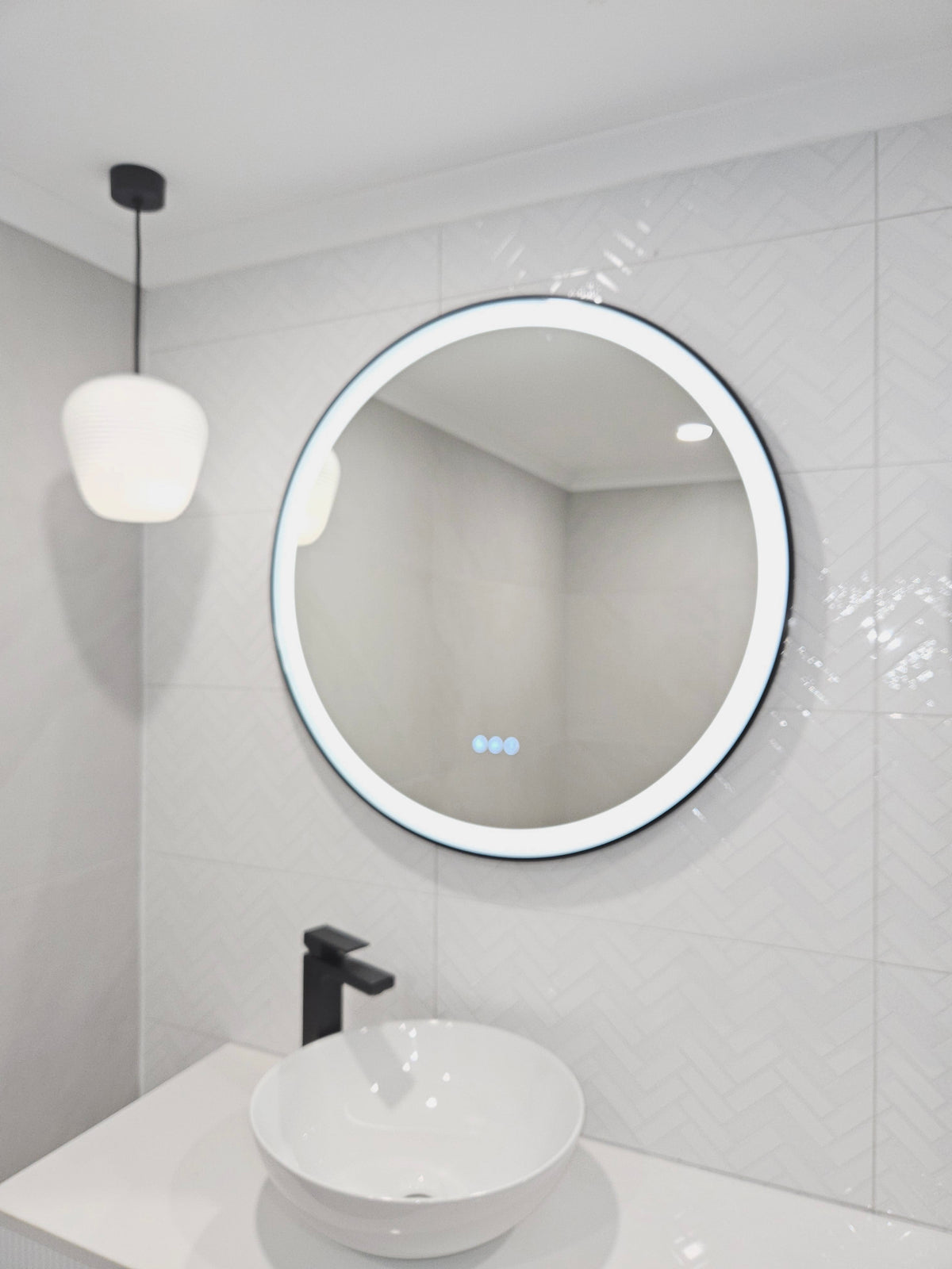 Smart Circle Black Frame LED Mirror on the Left Side of Bathroom with Pendant Light Fixture