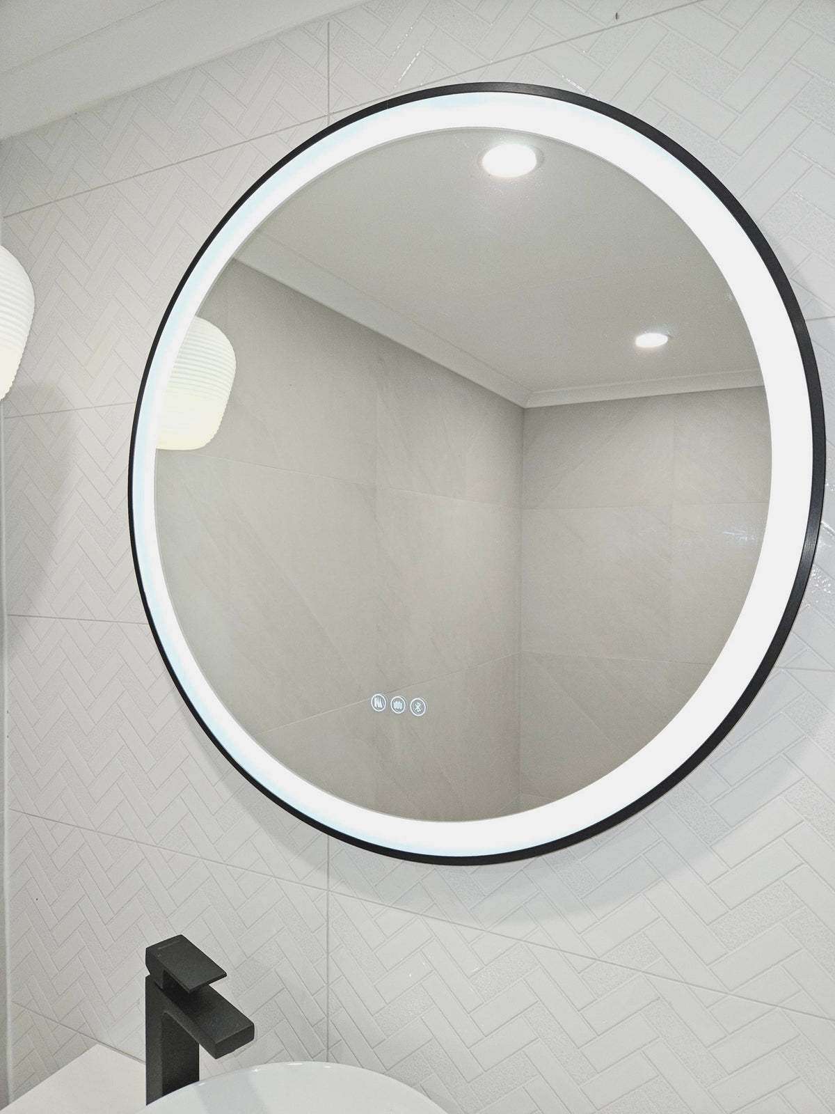 Smart Circle black frame LED Mirror on the left side of the powder room