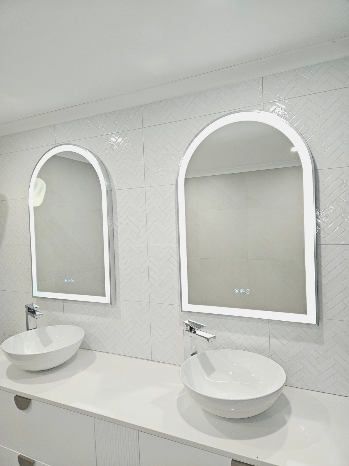 Bird's-eye Perspective of Two Arch-Shaped Smart LED Mirrors in bright all-white bathroom