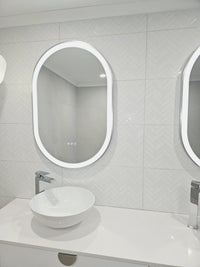 Modern Smart LED Mirror adorned with Silver Frame and Triple-Touch Buttons in white bathroom