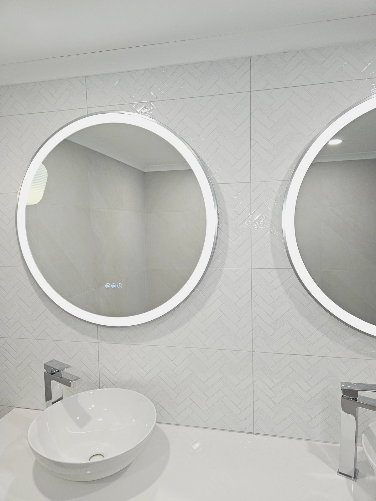 Two silver frame Smart Circle LED Mirrors on white bathroom 