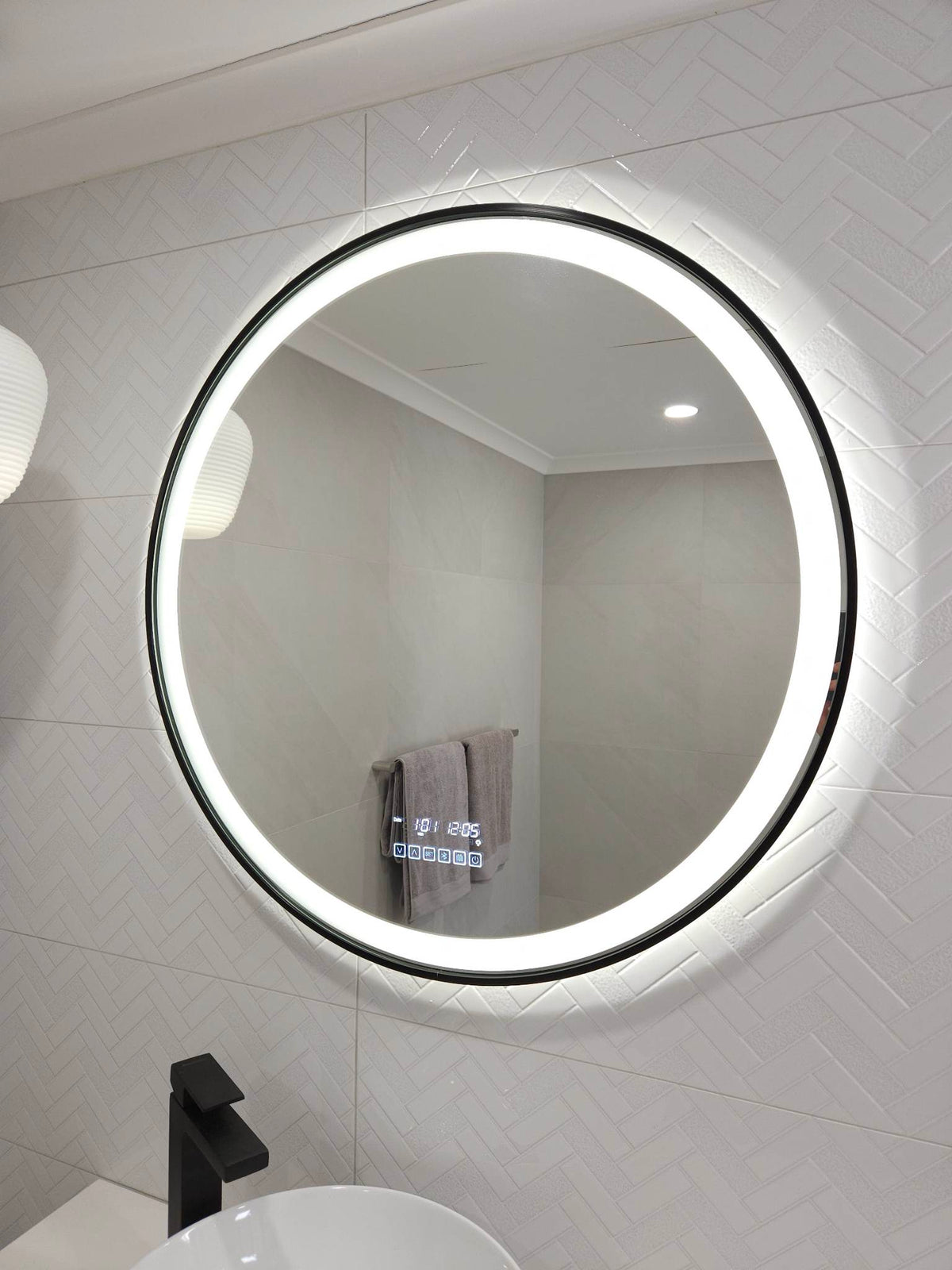 White Bathroom with Side View of Illuminated Black-Framed InVogue Circle Smart LED Mirror