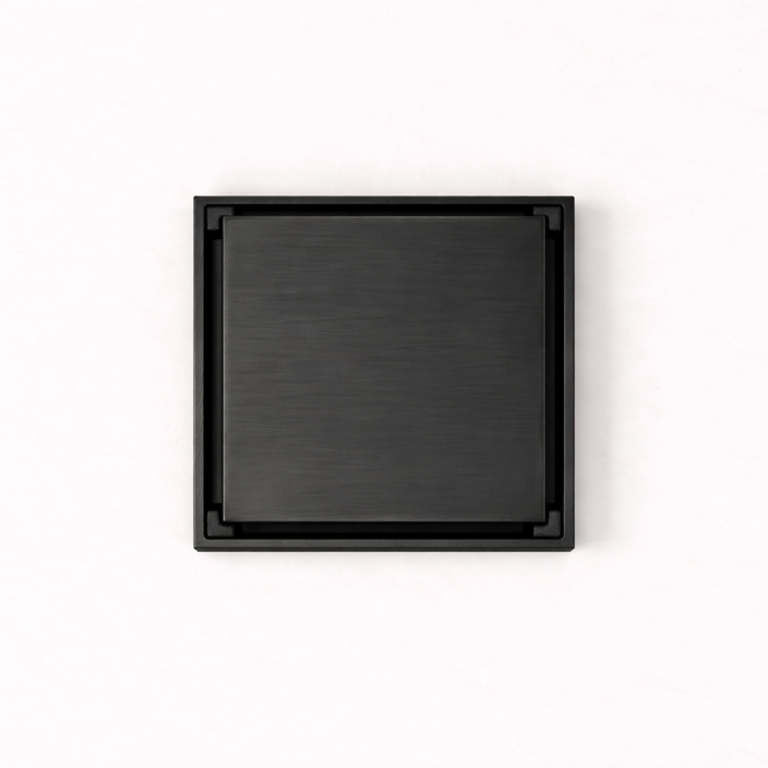 Granada Tile Insert Floor Waste in Matte Black, top-down view of the square brushed cover on a plain white background