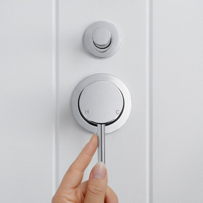 Cannes Shower Diverter and Mixer in Chrome, hand holding the lever below the diverter on white vertical-panelled wall