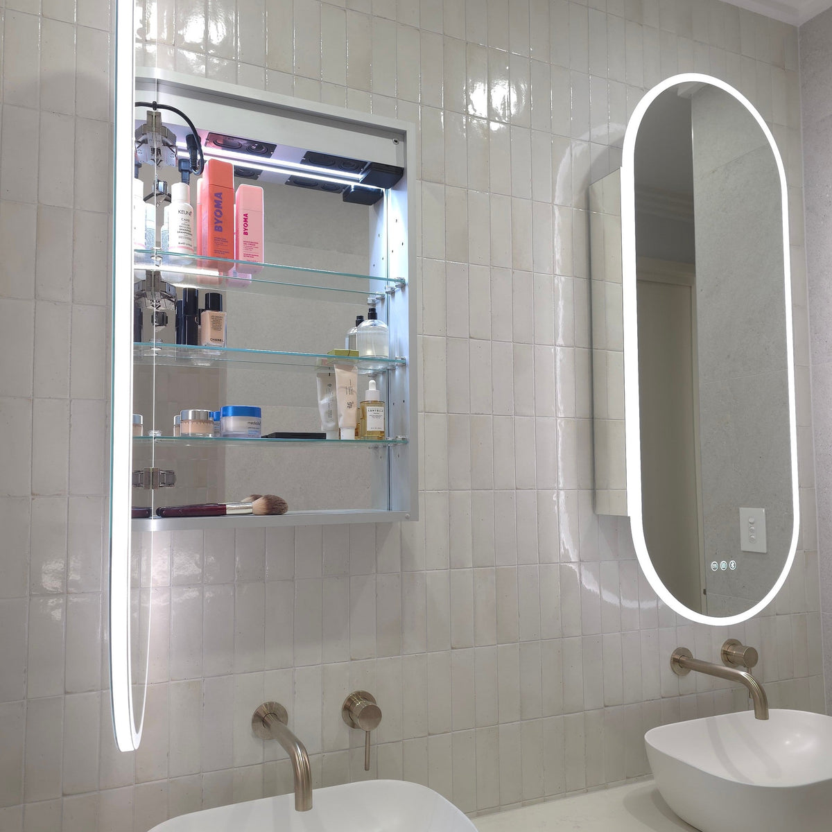 Frameless LED mirror cabinet showing adjustable internal storage shelves and bluetooth speakers