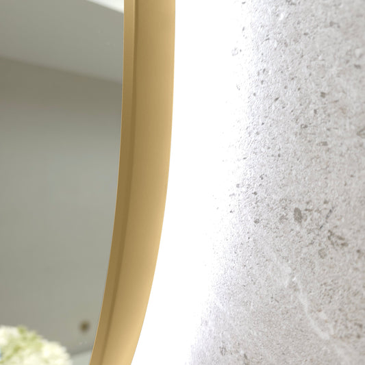 Close-up of the Bellagio gold frame edge, which wraps around the glass, with the LED glow on the wall