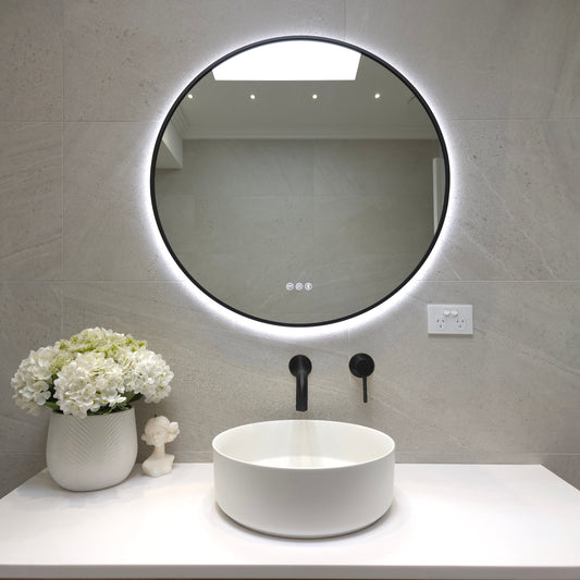Bellagio round backlit LED mirror in Matte Black above a round basin with matching Matte Black tapware