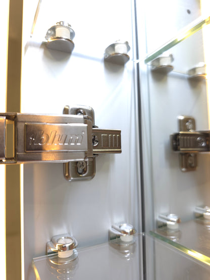 Close up view of Frameless LED mirror cabinet with adjustable glass internal storage shelves and Blum brackets