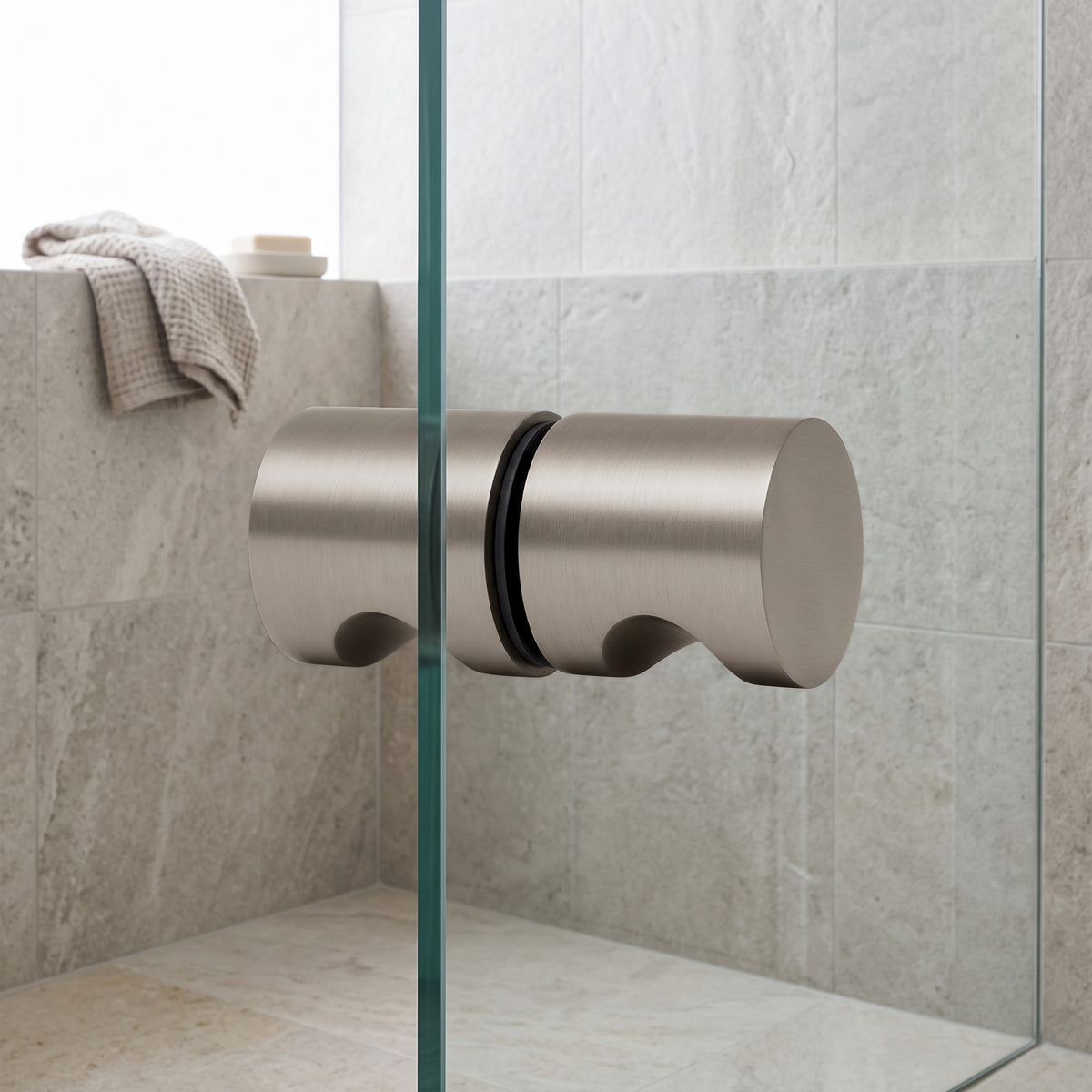 Corfu Shower Door Handle in Brushed Nickel on a glass shower door