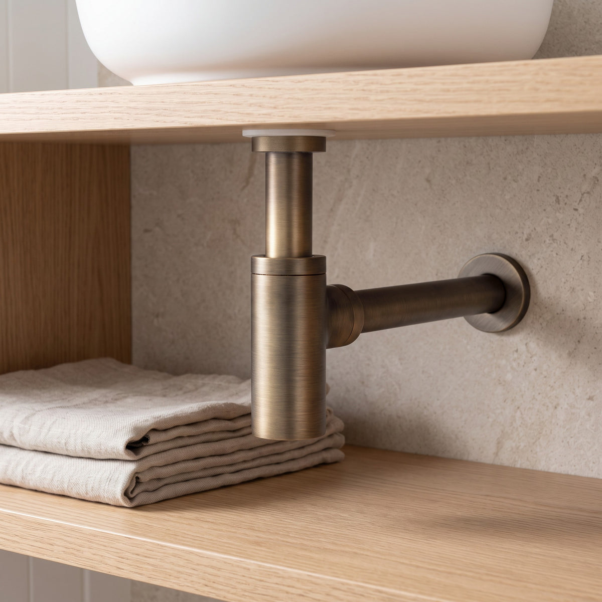 Firenze Basin Bottle Trap in Antique Brass in a bathroom