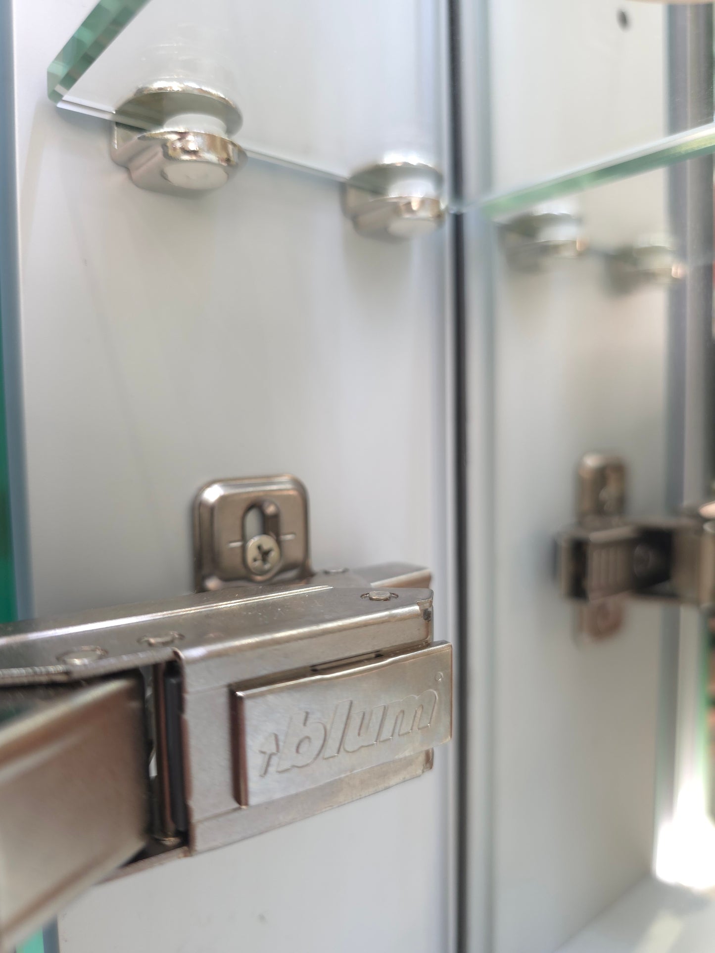 Interior storage space inside frameless bathroom mirror cabinet showing softclose brackets