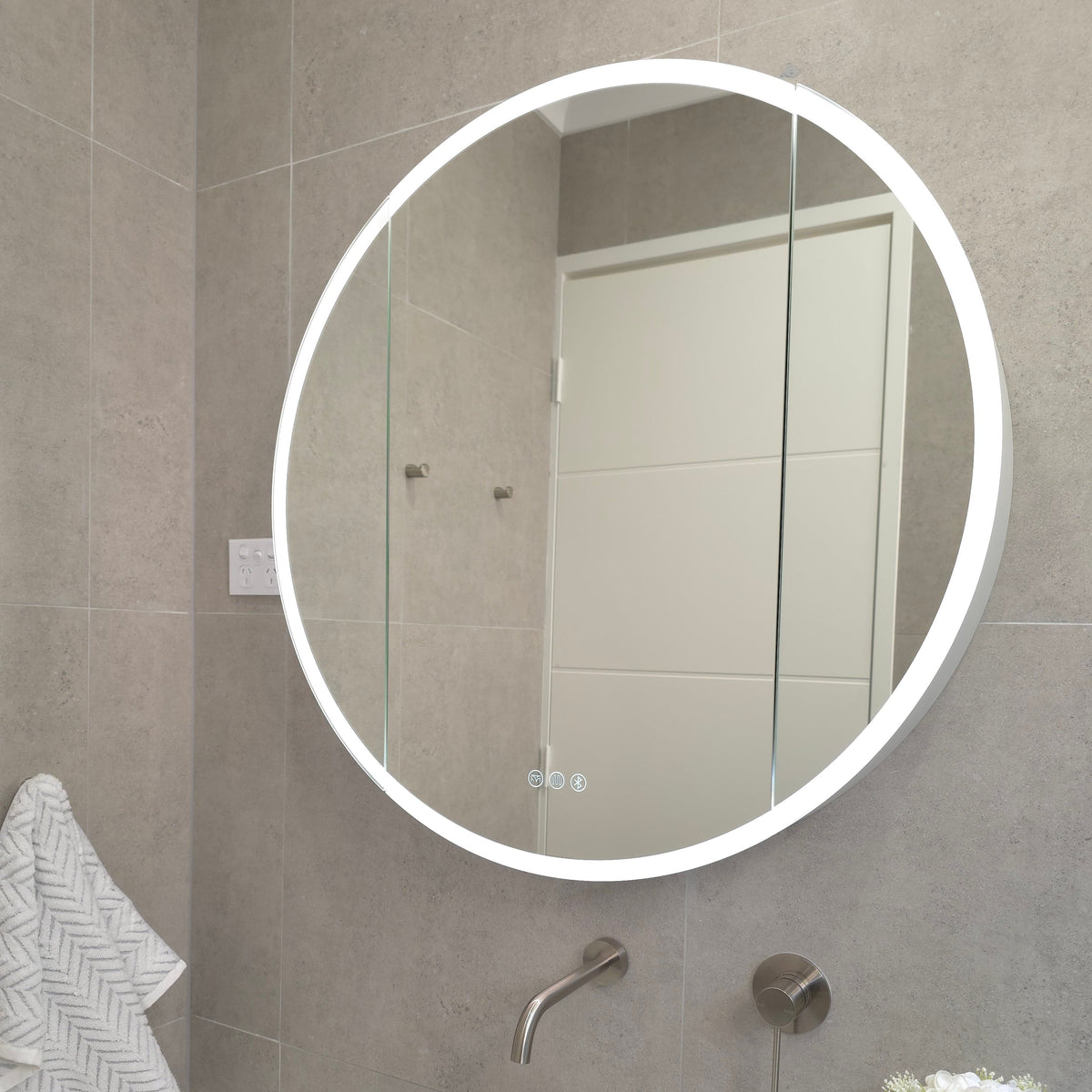 Exterior view of round LED mirror cabinet with built-in bluetooth speakers and sensor lighting