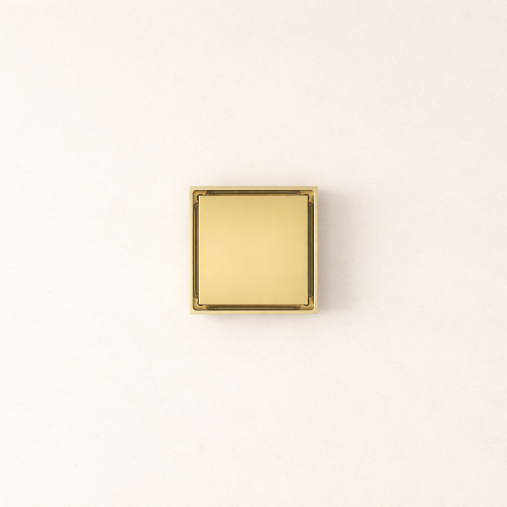 Granada Tile Insert Floor Waste in Brushed Brass, top-down view of the square metal cover on a plain white background