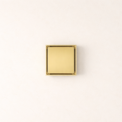 Granada Tile Insert Floor Waste in Brushed Brass, top-down view of the square metal cover on a plain white background