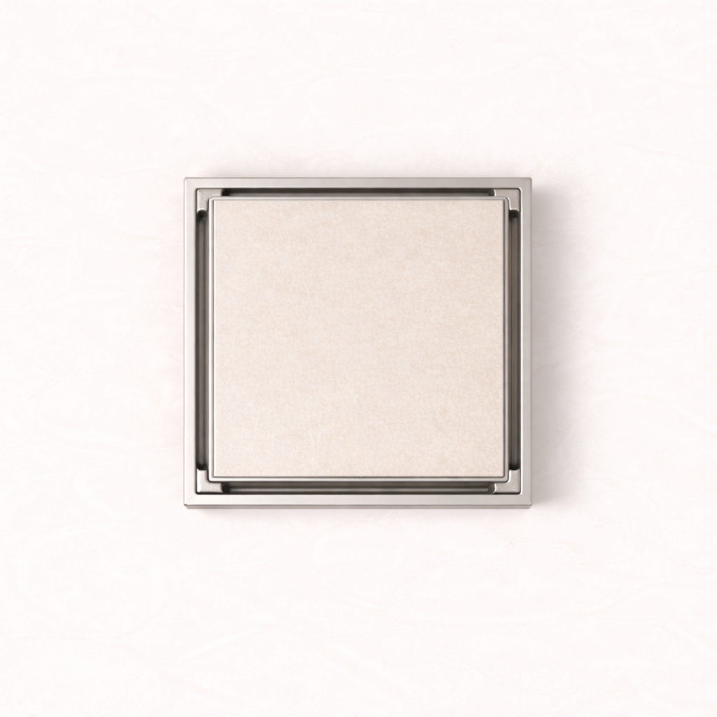 Granada Tile Insert Floor Waste in Brushed Nickel, top-down view, light stone tile in the cover on a plain white background