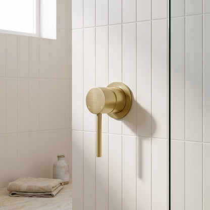 Milano Wall Mixer in Brushed Brass in a bathroom