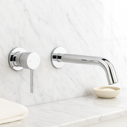 Milano Wall Spout Plus Wall Mixer in Chrome, mixer and long spout on white marble wall above a marble ledge with soap dish