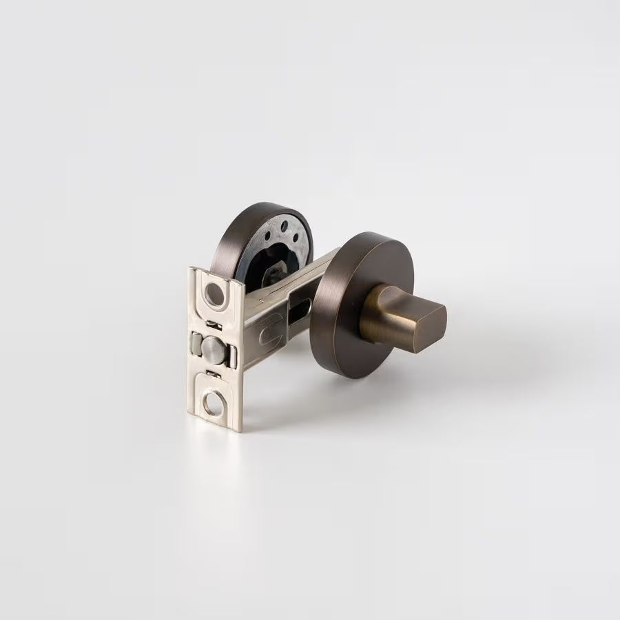 Prague Door Lock in Antique Brass, lock mechanism with latch and both roses on a plain white background