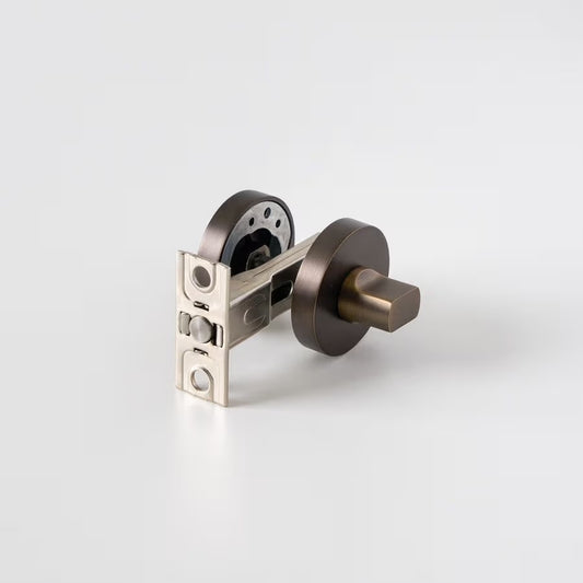 Prague Door Lock in Antique Brass, lock mechanism with latch and both roses on a plain white background