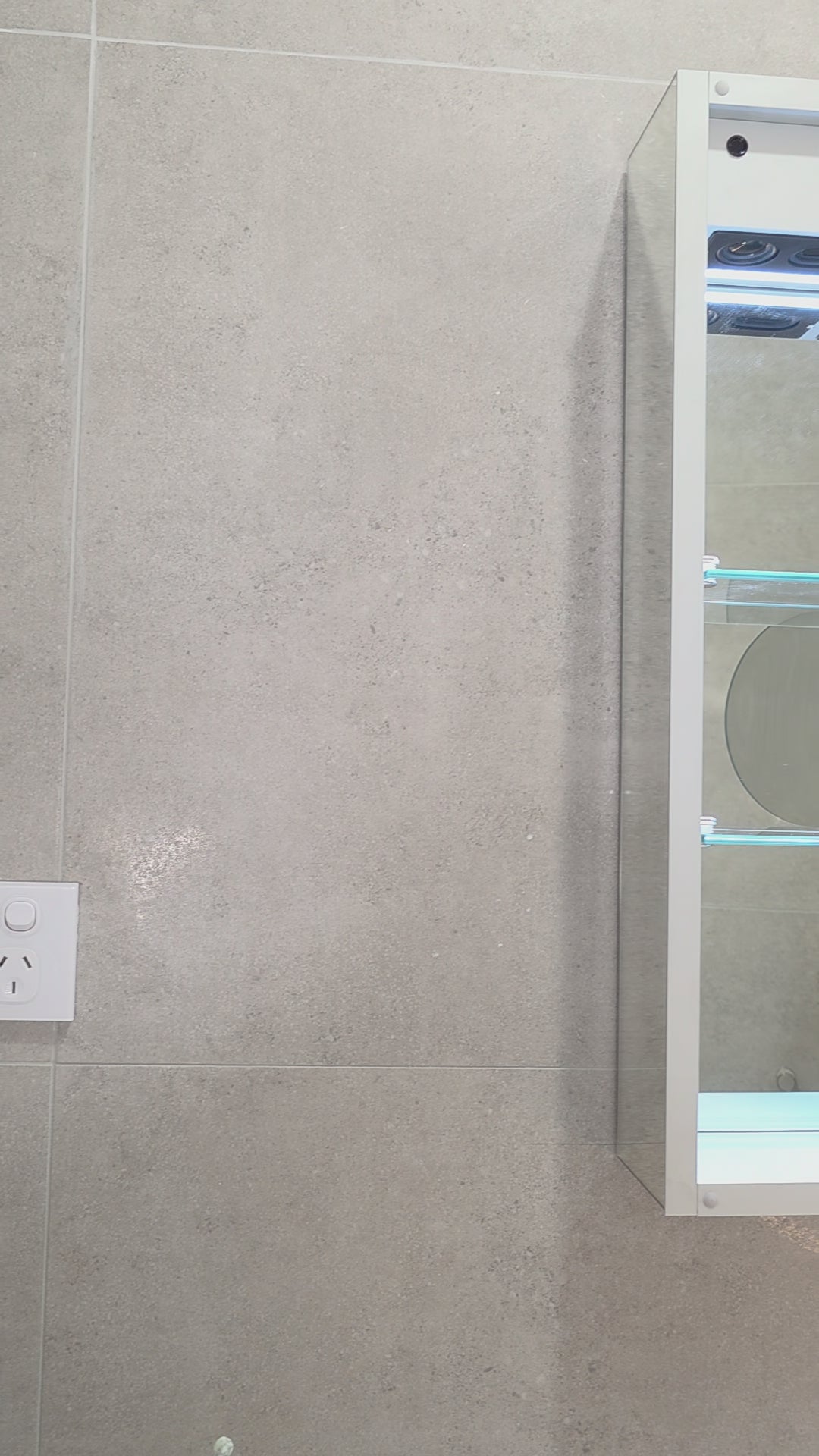 Video demonstration of external view of irregular led mirror cabinet with bluetooth speakers and demister