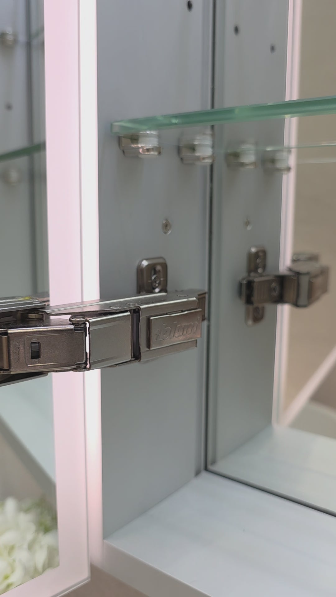 Frameless LED mirror cabinet showing internal storage and lighting by Invogue
