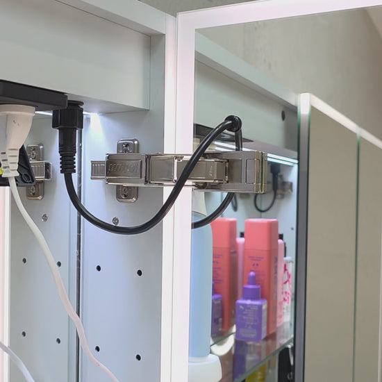 Frameless LED mirror cabinet showing internal glass shelving and lighting