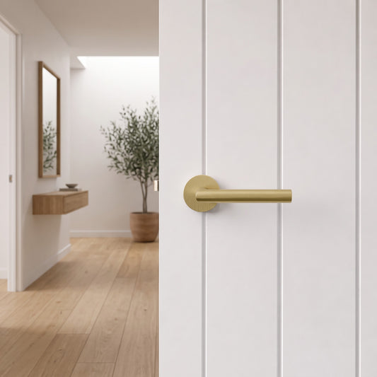Santorini Door Handle in Brushed Brass on an interior door