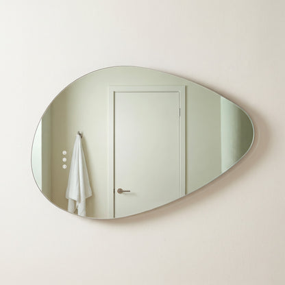 The Sorrento frameless backlit LED mirror, 800 x 550mm, backlight off, floating on a warm-white wall