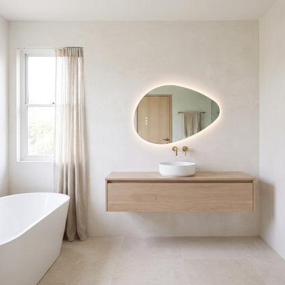 The Sorrento frameless backlit LED mirror, 800 x 550mm, above an oak vanity in a bright bathroom with a freestanding bath