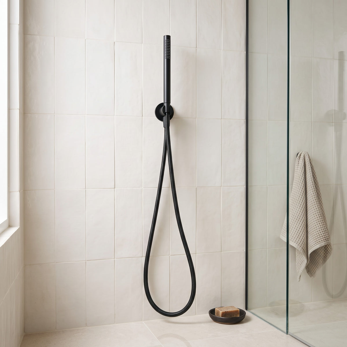 Versailles Handheld Shower Head with Hose in Matte Black in a shower