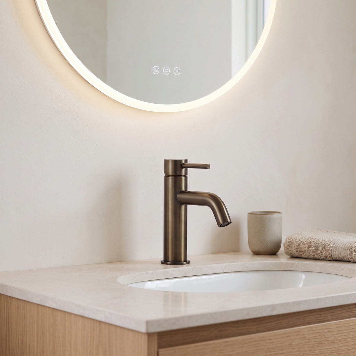 Vienna Short Basin Mixer in Antique Brass in a bathroom