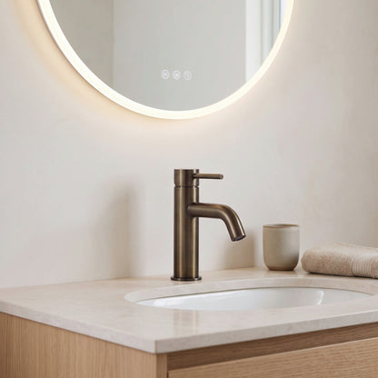 Vienna Short Basin Mixer in Antique Brass in a bathroom