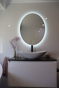 Soothing Ambiance from Soft Glow of Lighted Backlit LED Mirror in Pristine White Glossy Bathroom