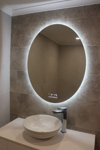 Backlit LED light from the Oval Smart LED Mirror brightens the entire bathroom