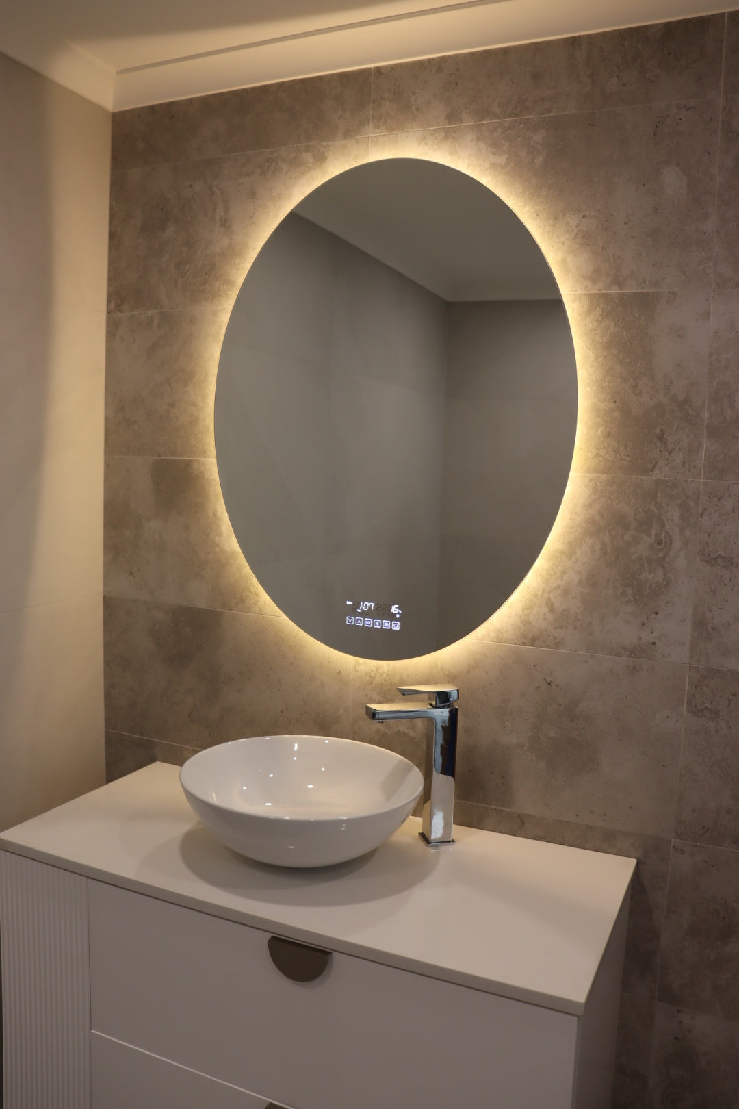 Relaxing View of Vanity Space with Yellow Light from Smart LED Mirror on Greyish Brown Tiled Wall
