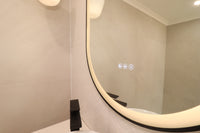 Close-Up of Triple Touch Buttons on Black Frame Oval Smart LED Mirror in Cream Themed Powder Room