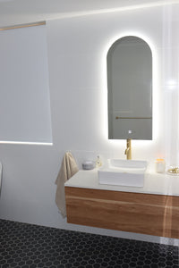 White Bathroom with Backlit LED Mirror, Black Hexagon Floor Tiles, and White-Brown Vanity Cabinet