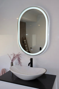 Right Side View of Vanity Mirror with White Vessel Sink and Black Countertop