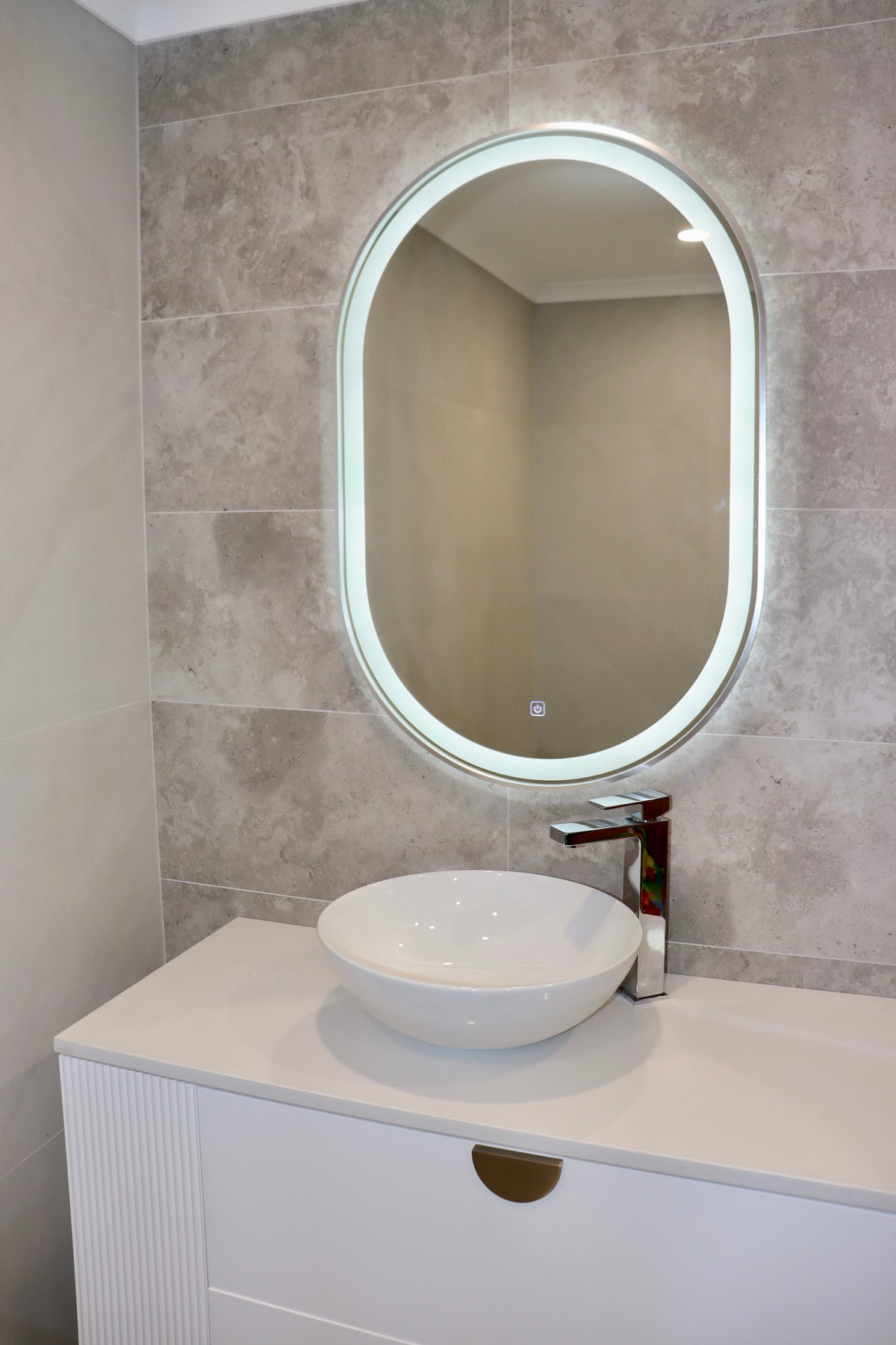 Left Silver Frame Oval LED Mirror in Neutral Bathroom