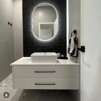 Black subway-tiled bathroom foyer with LED Mirror, floating cabinet, and passage to the shower area